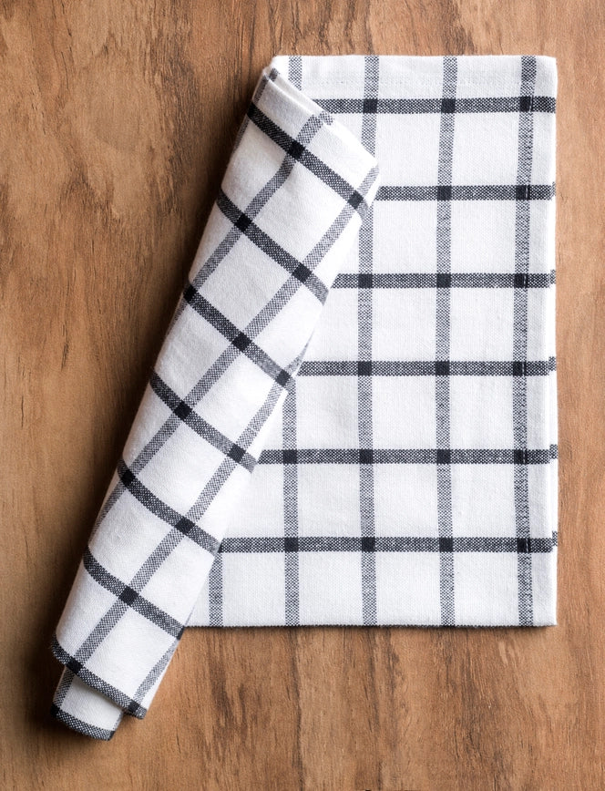Folded checkered towel on a wooden surface