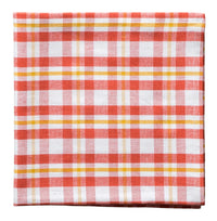 Red, white, and yellow checkered fabric napkin on a white background