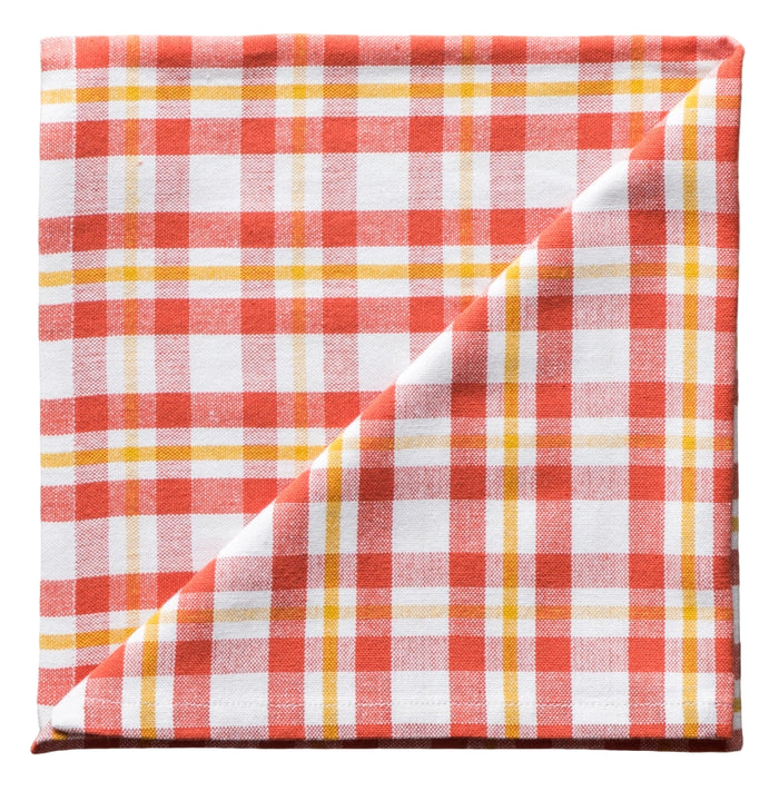 Folded red, white, and yellow checkered fabric napkin on a white background