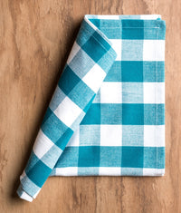 Blue and white checkered napkin on a wooden surface