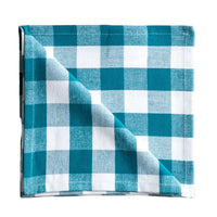 Folded blue and white checkered fabric napkin on a white surface