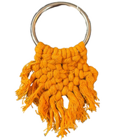 Orange macrame keychain with a metal ring on a white background