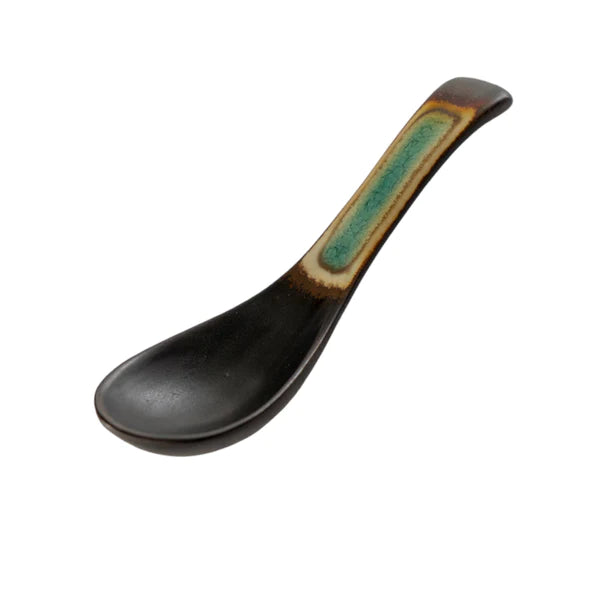 Black ceramic spoon with a green and brown handle on a white background