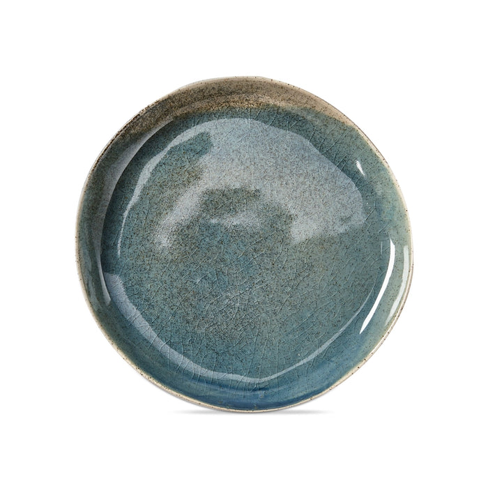 Blue, reactive glaze organic shaped round salad plate on a white background