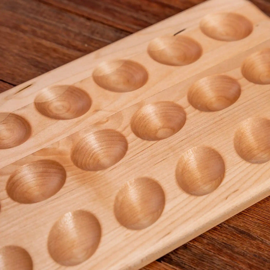 Wooden board with circular holes on a wooden surface