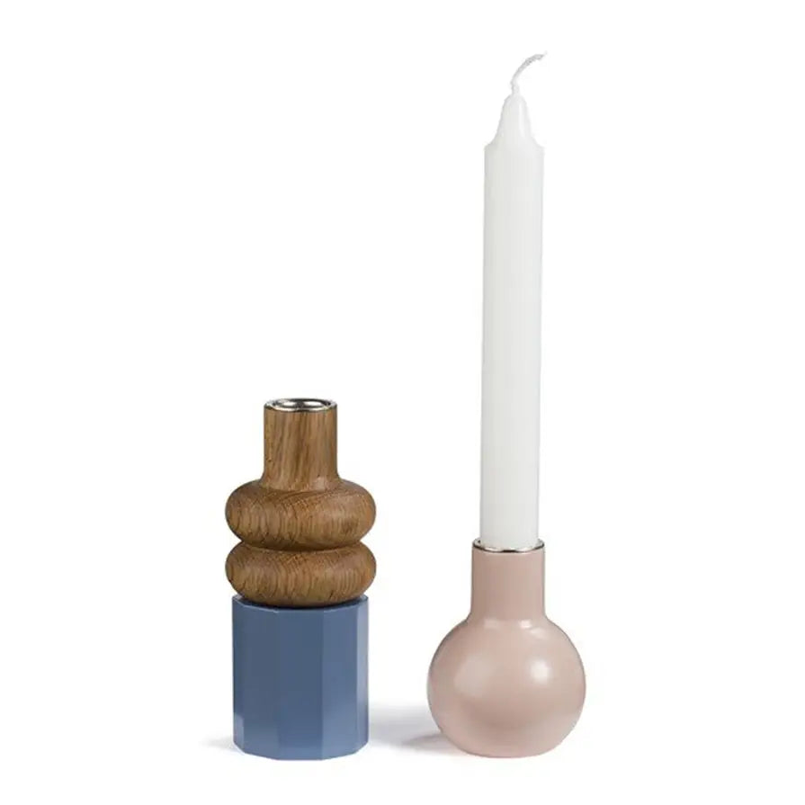 wood, blue and pink candle stick holder in Nordic style with a white candle on a white background