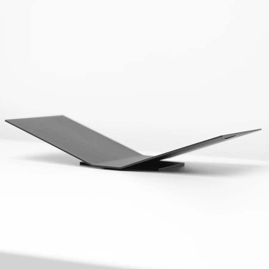 black metal book display stand on white background