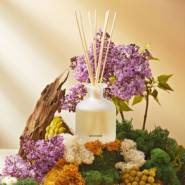 glass vessel with reed diffusers and florals