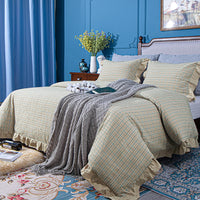 bedroom with blue wall and taupe and grey bedding