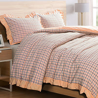 bed with ruffled edge bedding in pink and other colors