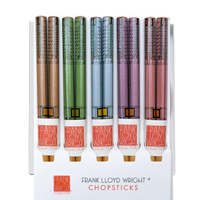 Set of Frank Lloyd Wright chopsticks with colorful handles on a white background
