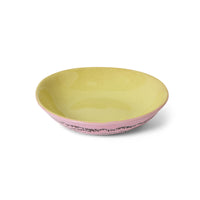 Two-tone ceramic bowl with pink bottom and yellow top on a white background