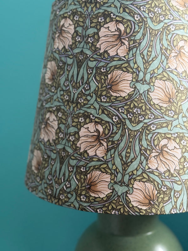 Floral patterned lampshade on a teal background