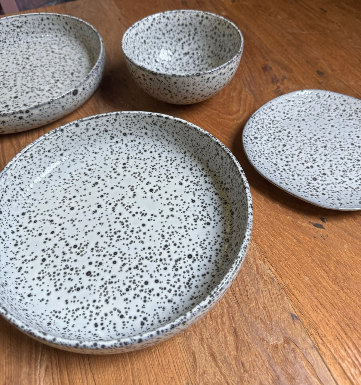 set of gray speckled plates on a wooden table