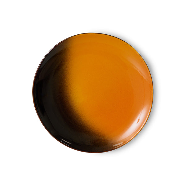 Round ceramic plate with gradient color from black to orange on a white background
