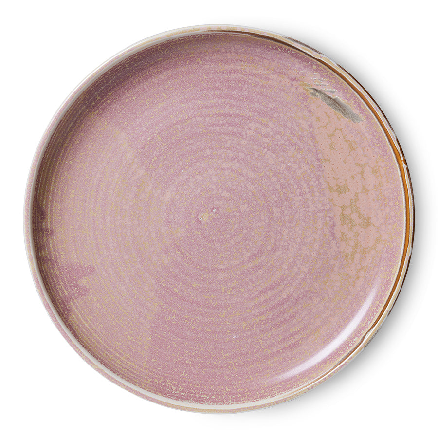Round ceramic plate with a purple glaze on a white background