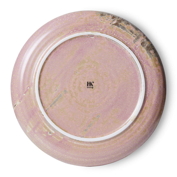 Round ceramic plate with a marbled design on a white background