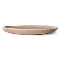 round pink  textured cylindrical plate on a white background