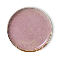 Round ceramic plate with a purple glaze on a white background