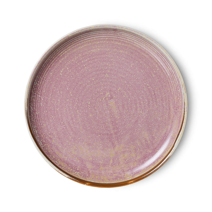 Round ceramic plate with a purple glaze on a white background