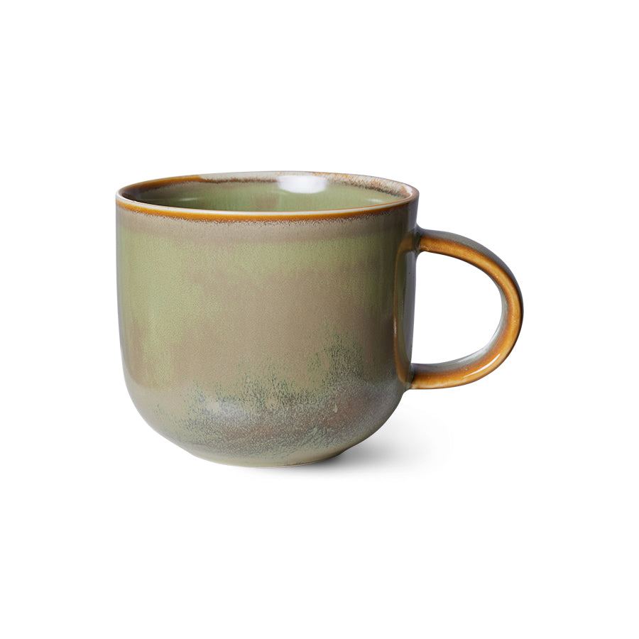 Green ceramic mug with brown handle on a white background