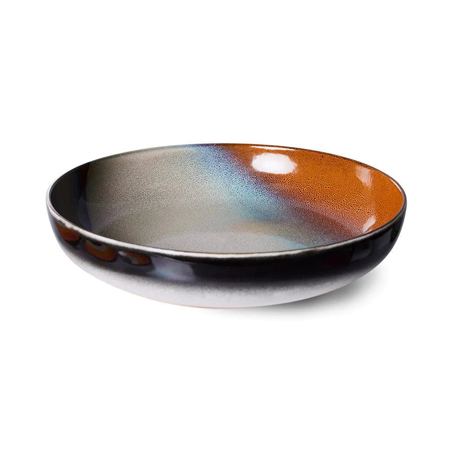 Ceramic bowl with multicolored glaze on a white background