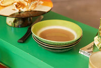 curry bowls in green and brown retro colors on a green table