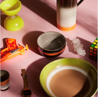 curry bowls in green and brown retro colors on a pink table