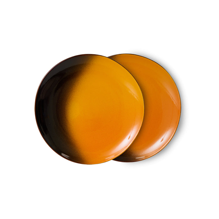 Two orange ceramic plates on a white background