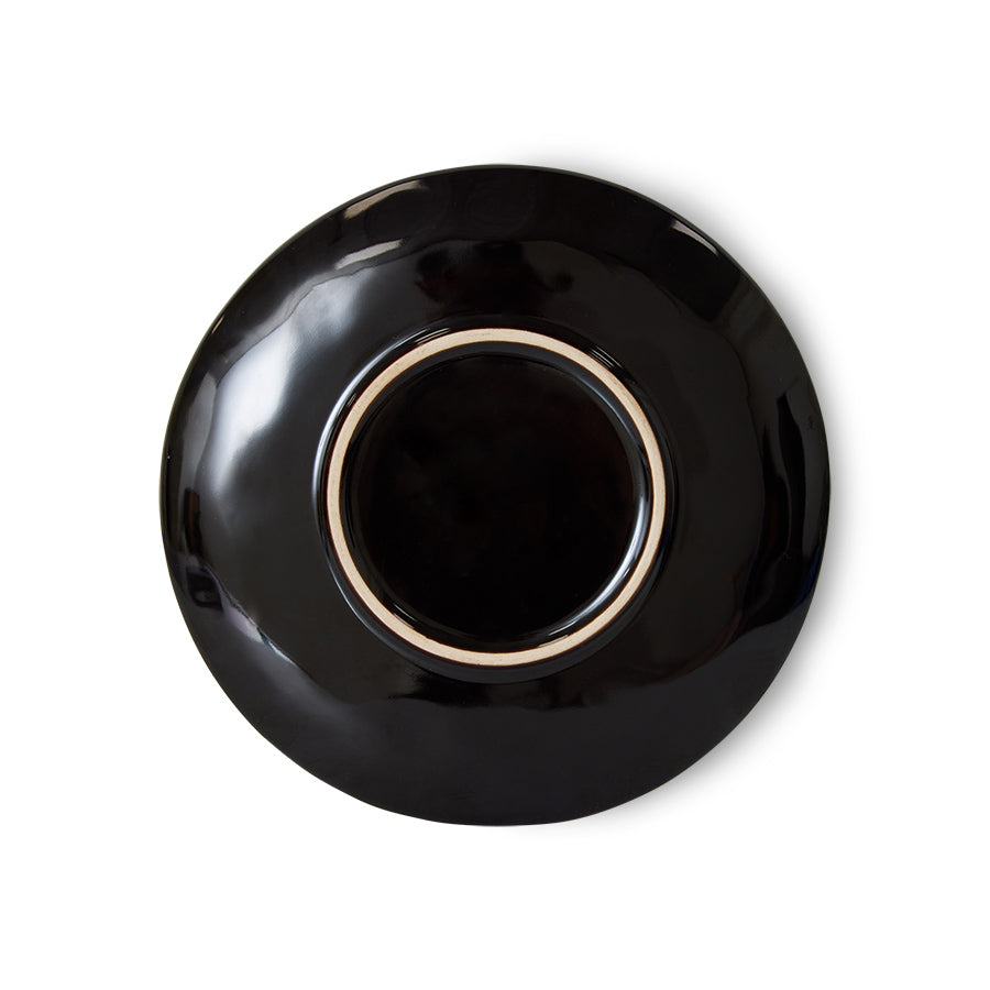 Black ceramic saucer on a white background