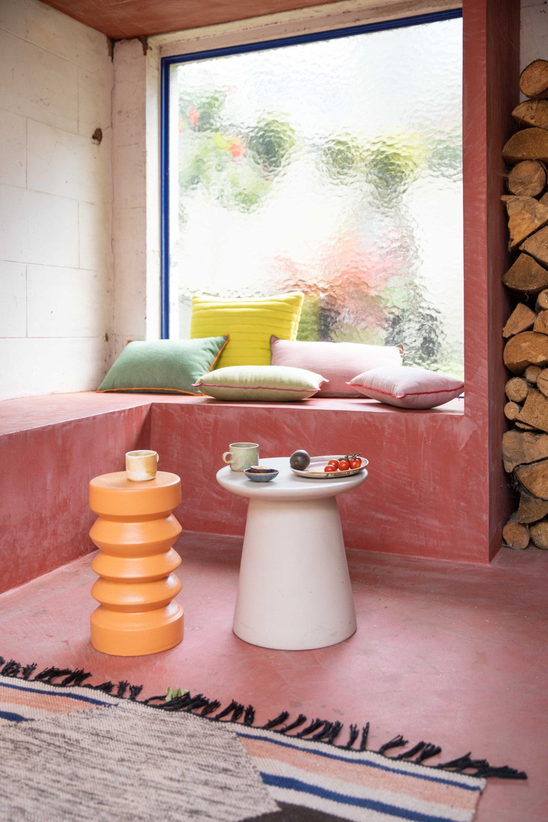 small, flat bowl made from blue porcelain on an earthenware side table in a patio