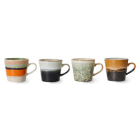 Set of four ceramic mugs with gradient color designs on a white background