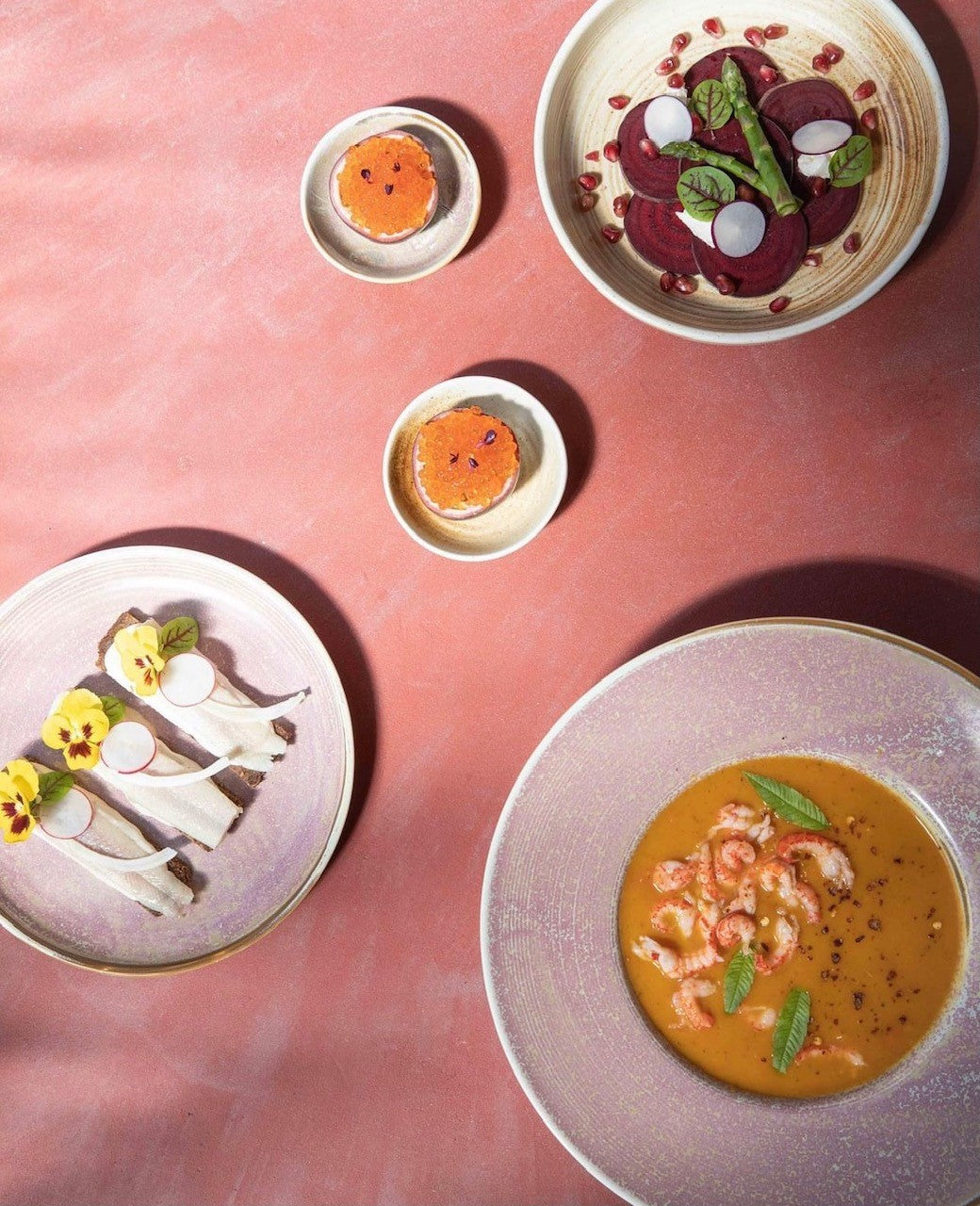 Assorted dishes on a pink surface