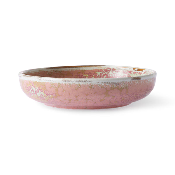 Pink ceramic bowl with speckled pattern on a white background