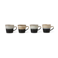  four ceramic mugs with a two-tone design on a white background