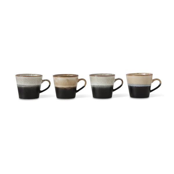  four ceramic mugs with a two-tone design on a white background