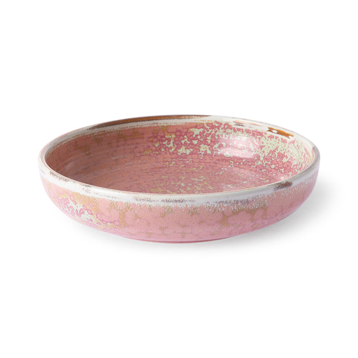 Pink ceramic bowl with speckled pattern on a white background
