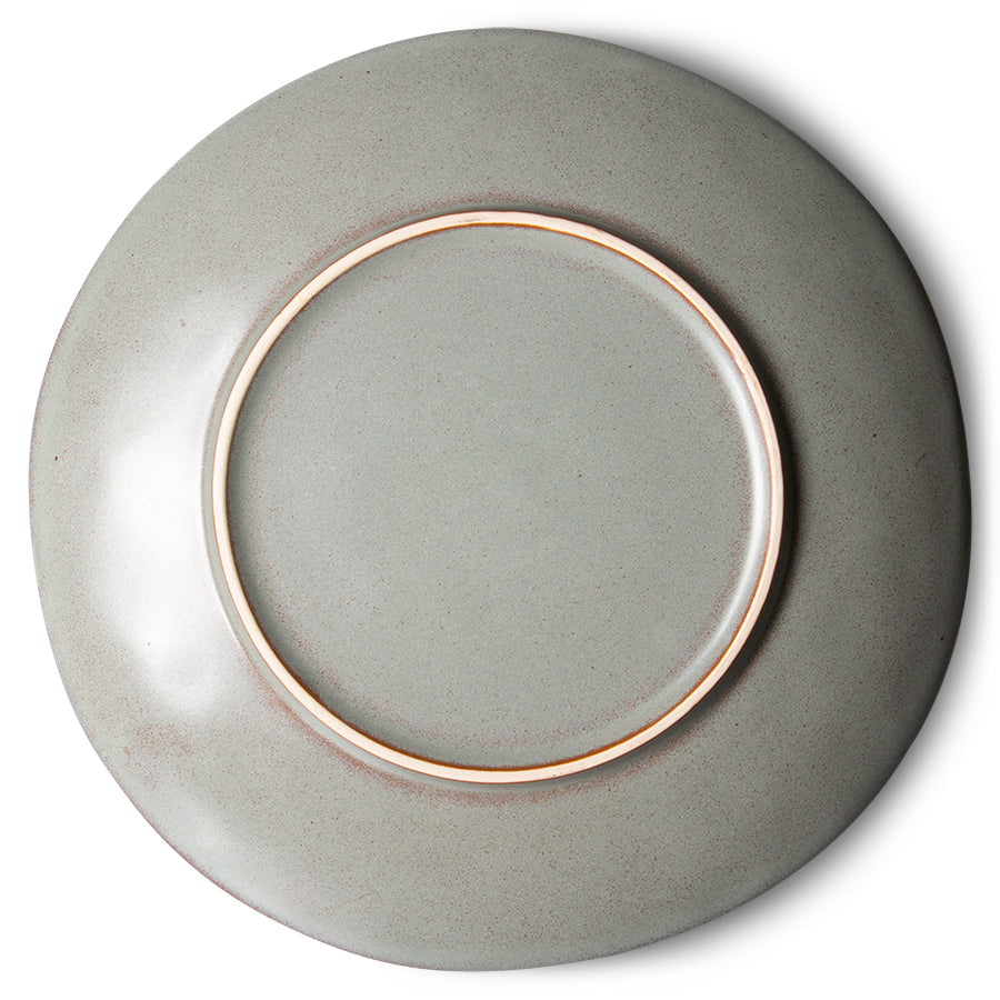 Ceramic plate with a copper rim on a white background
