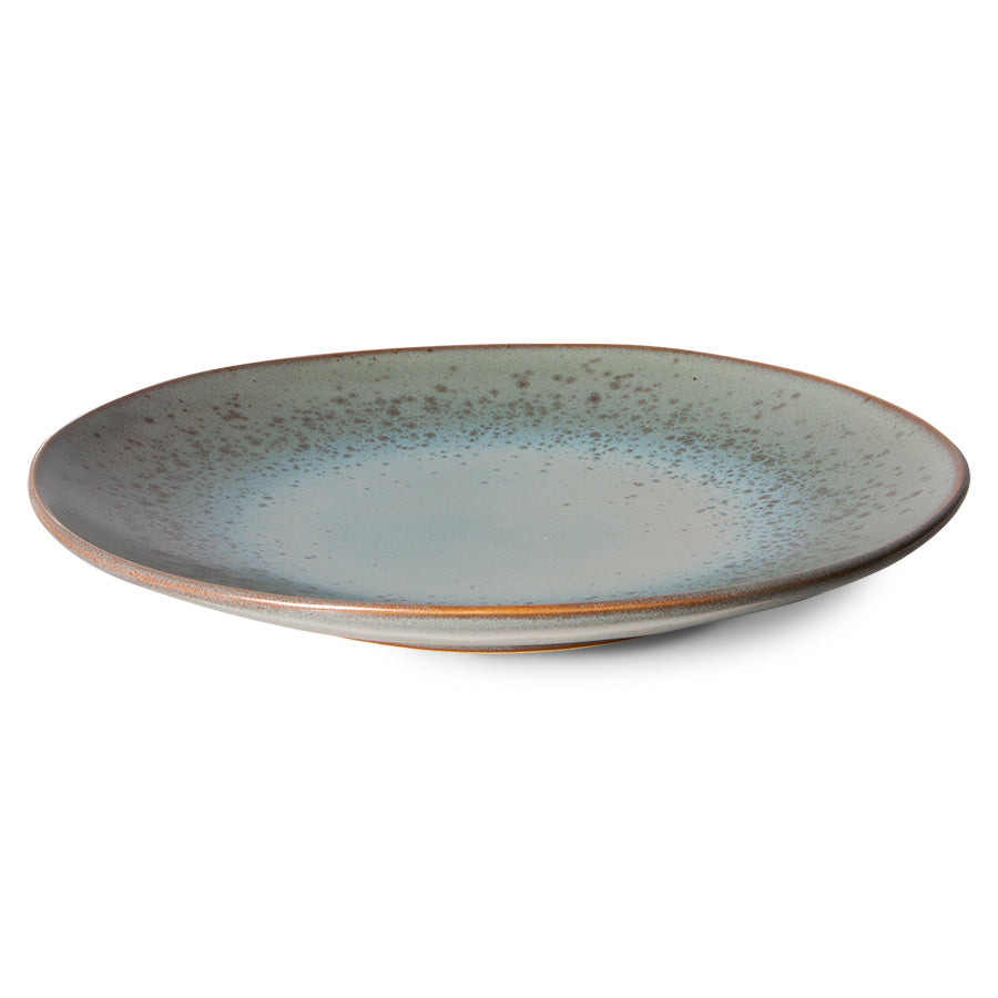 Ceramic plate with a speckled design on a white background