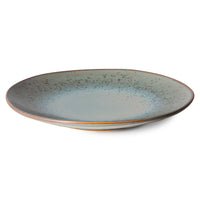 Ceramic plate with a speckled design on a white background