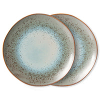 Two ceramic plates with a speckled design on a white background