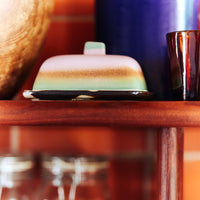 Decorative items on a wooden shelf with a blurred background