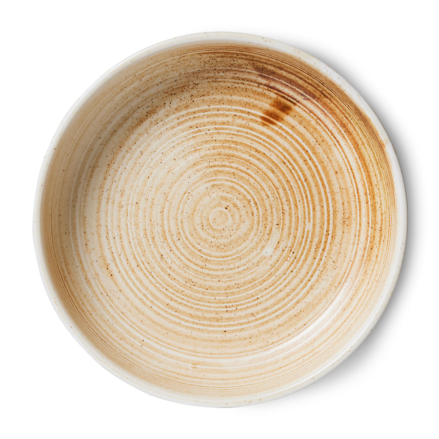 Ceramic bowl with concentric circular pattern on a white background