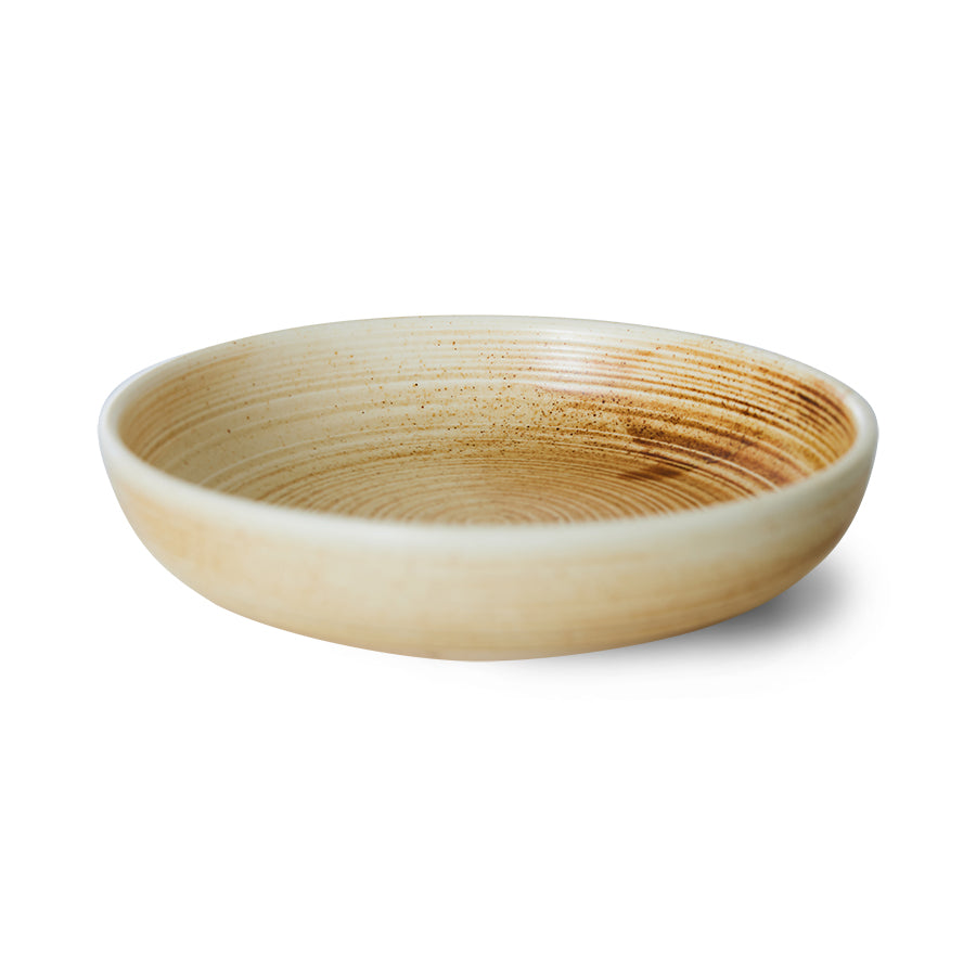 Round ceramic bowl with a textured surface on a white background