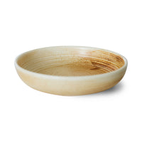 Round ceramic bowl with a textured surface on a white background