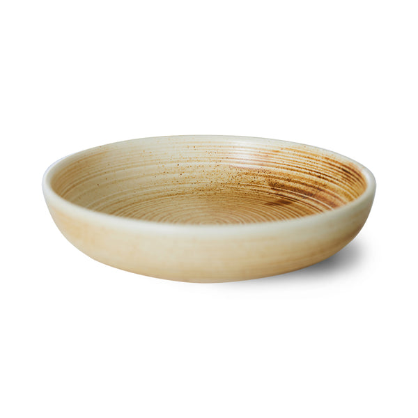 Round ceramic bowl with a textured surface on a white background