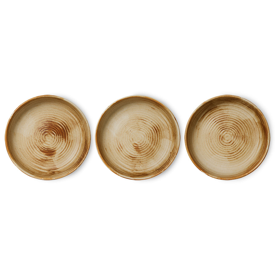 Three ceramic deep plates with concentric circle patterns on a white background