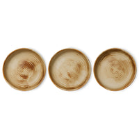 Three ceramic deep plates with concentric circle patterns on a white background