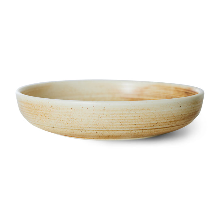 Round ceramic deep plate on a white background