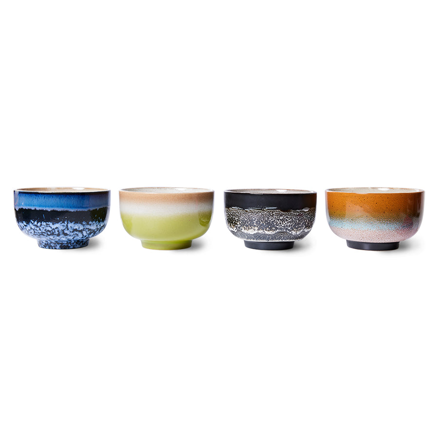 Set of four ceramic bowls with unique color patterns on a white background